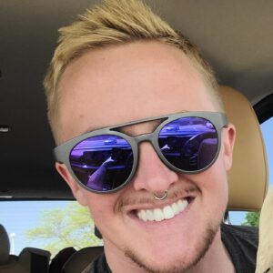 White person with black sunglasses smiling